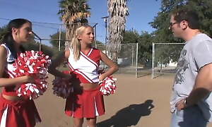 Cheerleader Girls Look into Football Game Beside Quarterback