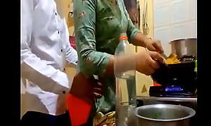 indian progressive married couple romance alongside kitchen.